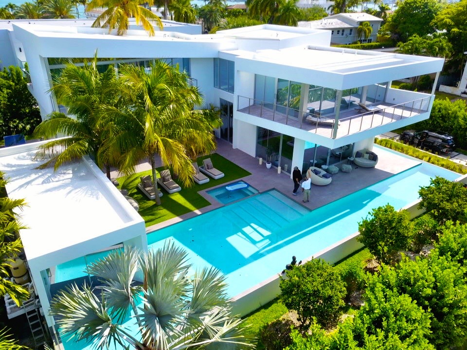 Modern Miami Beach estate with white pool inspected by Home Pro Miami